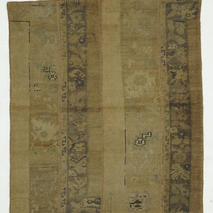 May include: A rectangular, vintage-style rug with a patchwork design. The rug features vertical stripes in shades of tan, olive green, and brown. Decorative borders and scattered geometric patterns add visual interest. The rug has a worn, antique appearance.
