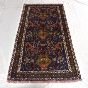 May include: A rectangular area rug featuring a deep blue field with a repeating pattern of stylised green and brown urns, geometric floral motifs, and animal figures. The rug is framed by a dark brown border with intricate geometric patterns.