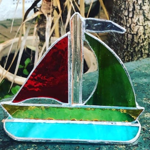 Beautiful stained glass sailing boats mounted on glass mirror