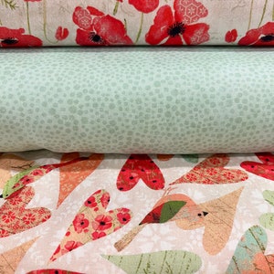 May include: Three fabric swatches with different patterns. The top swatch features a white background with red poppy flowers. The middle swatch is a solid green with a subtle speckled pattern. The bottom swatch has a white background with a repeating pattern of red hearts, birds, and leaves.