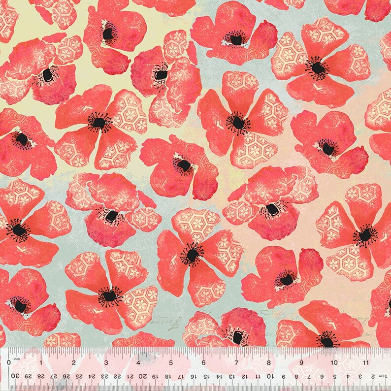 May include: A fabric with a repeating pattern of large, stylized red poppies with black centers and white geometric accents. The background has a light blue and yellow gradient. A ruler is at the bottom, showing inches.