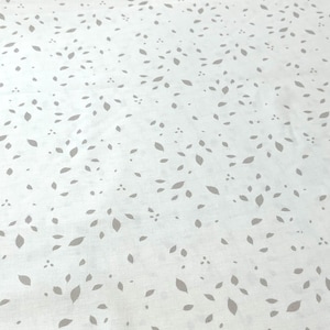 May include: White fabric with a subtle pattern of gray leaves scattered across the surface.