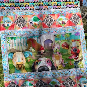 May include: A vibrant dog-themed quilt with multiple dog illustrations and patterns. The quilt features a central panel with dogs near a doghouse, framed by geometric and patterned borders in bright shades of blue, red, and orange.