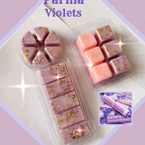 May include: Three wax melts in clear plastic packaging. The wax melts are pink and purple with gold glitter. The packaging says "Parma Violets".
