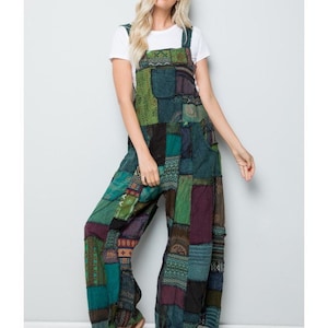 May include: A patchwork overall jumpsuit with a green, blue, and purple color scheme. The overall has a wide leg and is made of a soft, comfortable fabric.