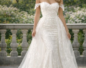 Vestido de novia de corte sirena con hombros descubiertos, encaje floral, cola desmontable, hecho a medida.