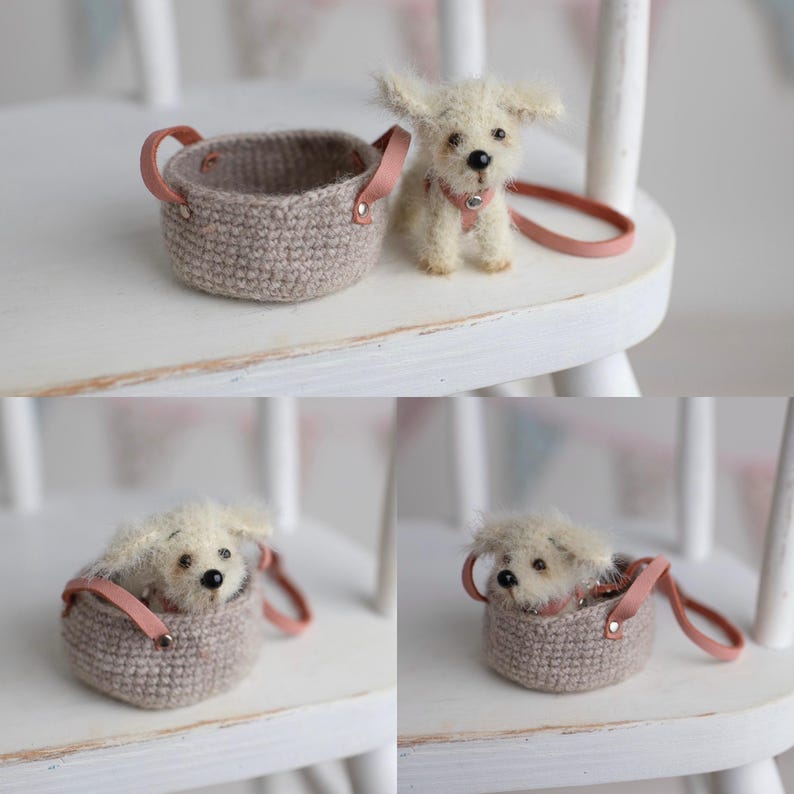 May include: A miniature, fluffy white dog with a pink collar and leash sits next to a small, crocheted basket with pink leather handles. The dog is positioned on a white chair, suggesting a pet accessory.