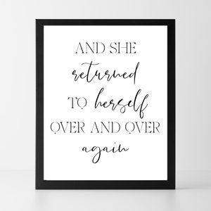 May include: A framed print with the quote "AND SHE returned TO herself OVER AND OVER again" in black script on a white background. The print is in a black frame.
