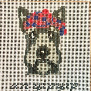 May include: Needlepoint canvas featuring a stylized dog with a red and blue floral headband. The dog is depicted in shades of gray and black, with the text "am yip yip" below the dog.