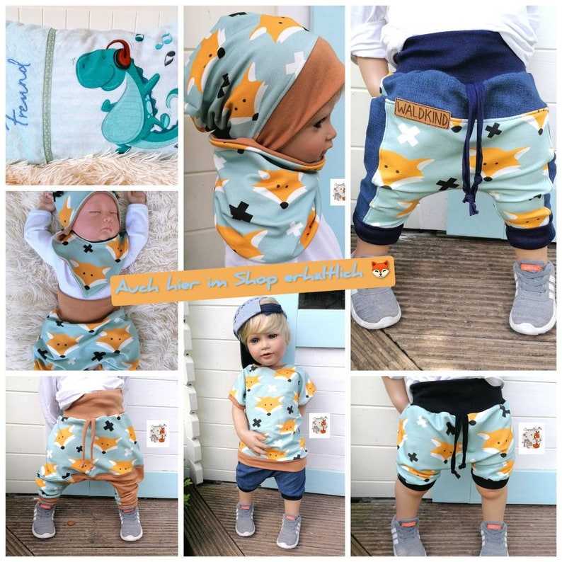 May include: A set of baby clothes featuring a fox print in blue, orange, and white. The set includes a beanie, a bib, a short-sleeved shirt, and a pair of shorts. The shorts have a denim panel on the side and a drawstring.