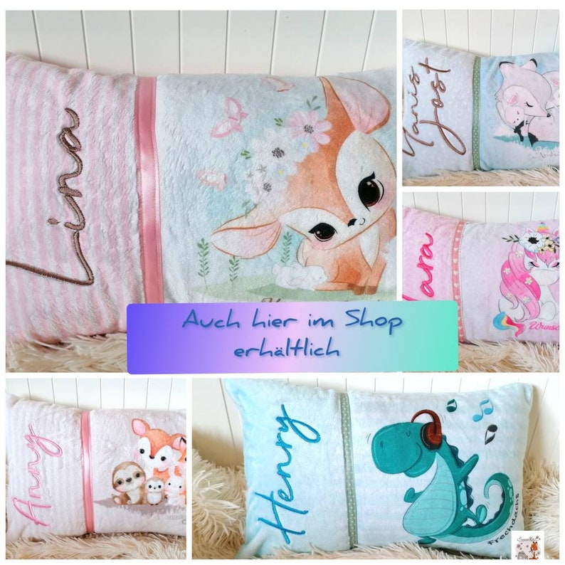 May include: A collection of personalized pillow covers with various animal designs. The pillows feature a pink and white striped fabric with a pink satin ribbon. The designs include a deer, a unicorn, a sloth, and a dinosaur. The pillows are embroidered with names such as "Anna", "Henry", "Laura", and "Janis Joest".