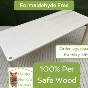May include: A white wooden platform for a pet bed or cage. The platform is formaldehyde free and made of 100% pet safe wood. The text "Order legs separately for this platform" is visible in the image.