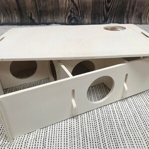 Large slot together multi chamber house for hamsters, made from formaldehyde free non toxic poplar plywood. Has 6 internal chambers, which are configurable to suit the quantity and sizes required. Main central entrance hole in front, with one in lid which can flipped to suit. Shown with lid partially removed.