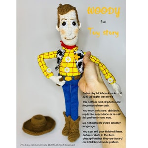 May include: Crocheted amigurumi toy of Woody from Toy Story. The toy is wearing a yellow and red plaid shirt, a brown vest with a white star, a blue denim vest, and brown cowboy boots. The toy is holding a sheriff's badge in his right hand. The text "WOODY from Toy Story" is written in yellow letters on a white background.