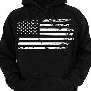 May include: Black hooded sweatshirt with a white distressed American flag design.