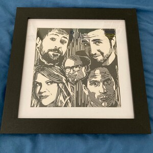 May include: Black and white framed print of five people's faces. The print is a woodcut style illustration.
