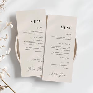 May include: Two beige wedding menu cards with black text. The top card says "MENU" and lists "Salad", "Main Course", and "Dessert". The bottom card says "MENU" and lists "Salad", "Main Course", and "Dessert". The bottom card is signed "Mollie Jones".