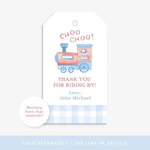 May include: A red and blue watercolor train with the text "CHOO CHOO!" and "THANK YOU FOR RIDING BY!"  The text "Love, John Michael" is below the train. A blue and white gingham pattern is at the bottom of the tag.