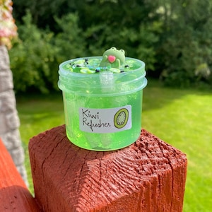 Premium Vector | Three Green Kiwi Fruit In A Clear Container With The