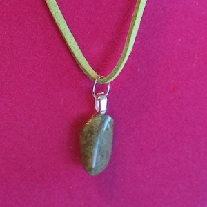 18&quot; green leather string cord necklace with green polished stone. Silver clasp. Unique colors & features in each stone.