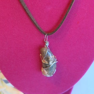 18&quot; brown leather string cord necklace with silver-wire-wrapped quartzite stone. Silver clasp. Unique colors & features in each stone.