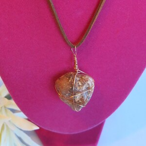 18&quot; brown leather string cord necklace with copper-wire-wrapped stone. Silver clasp. Unique colors & features in each stone.