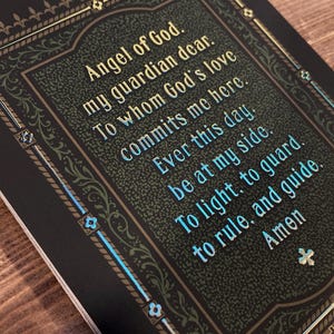 Original artwork based on the traditional Catholic devotion to our Guardian Angels, by BARITUS Catholic Illustration. Image depicts the reverse side of the holy card with brilliant metallic gold accents showing the traditional prayer to the Guardian Angel.