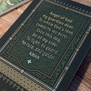 Original artwork based on the traditional Catholic devotion to our Guardian Angels, by BARITUS Catholic Illustration. Image depicts the reverse side of the holy card with brilliant metallic gold accents showing the traditional prayer to the Guardian Angel.