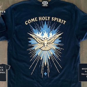 May include: A midnight navy short-sleeve t-shirt featuring a graphic on the back with the text COME HOLY SPIRIT. The design depicts a central dove with outstretched wings, surrounded by blue and cream-coloured rays and stylised flames.