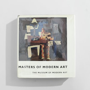 May include: A book titled "Masters of Modern Art" from The Museum of Modern Art. The cover features an abstract artwork with geometric shapes in white, brown, red, and blue against a dark background.