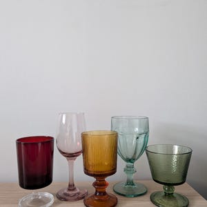 May include: A set of three ceramic mugs with a speckled, matte finish. The mugs are in shades of cream, light gray, and dark gray. Each mug has a simple, minimalist design, perfect for coffee or tea.