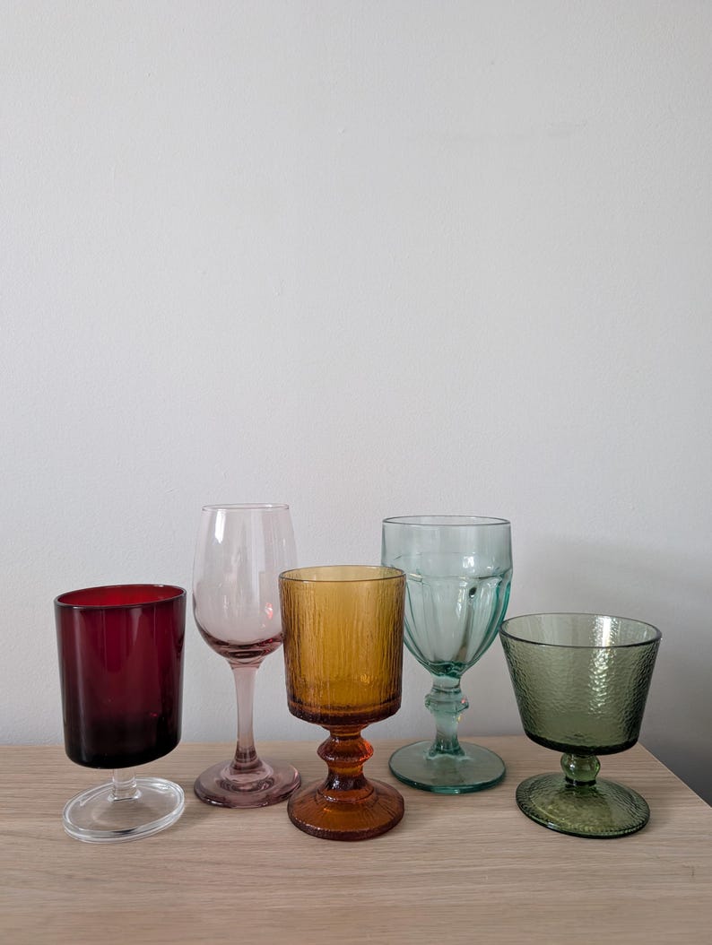 May include: A set of three ceramic mugs with a speckled, matte finish. The mugs are in shades of cream, light gray, and dark gray. Each mug has a simple, minimalist design, perfect for coffee or tea.