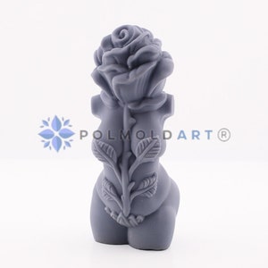 May include: A gray sculpture of a torso with a rose and foliage. The rose is at the top, and the stem and leaves run down the back. The sculpture has the text "POLMOLD ART®".
