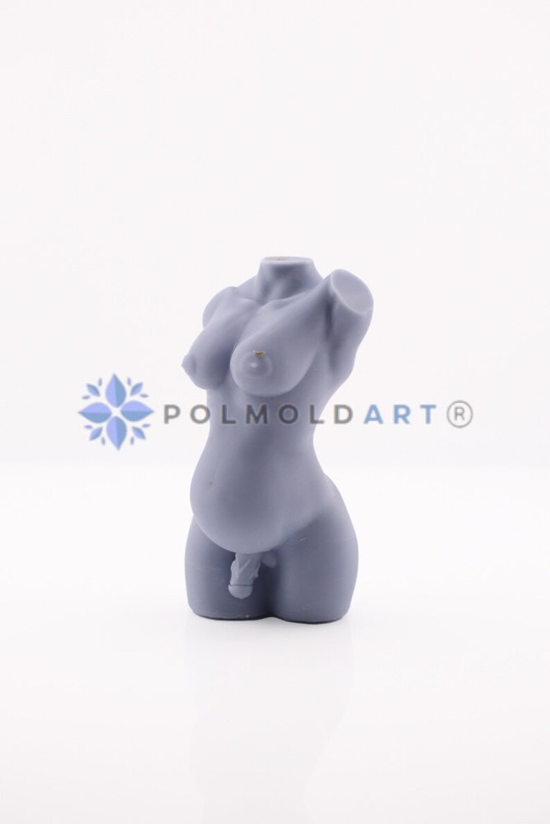 May include: A pale grey sculpture of a human torso, depicting breasts, a pregnant belly, and male genitalia. The sculpture is smooth and detailed, with the text "POLMOLDART&reg;" visible on the right side.