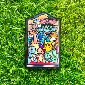 May include: A colorful stained-glass style pin featuring various cartoon characters. The pin has a black border and is set against a backdrop of green grass. The characters include a blue turtle, a yellow Pikachu, and a green plant-like creature.