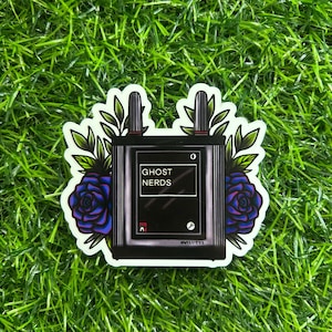 May include: A black and white sticker with a stylized illustration of a radio with the text "Ghost Nerds" and a blue and purple rose on each side.