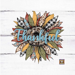 May include: A colorful sunflower with a patchwork design, including plaid, leopard print, and floral patterns. The sunflower has a blue and white text overlay that says "Thankful".