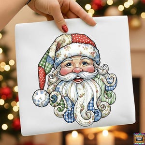 May include: A square white canvas featuring a colorful illustration of Santa Claus. Santa's face is rosy, with a long white beard and mustache. His hat and beard are patterned with floral, plaid, and polka dot designs. The image is held by a hand.