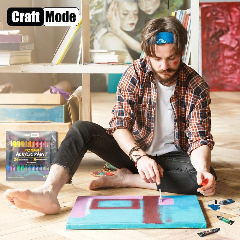 May include: A person paints on a canvas with a set of 24 premium acrylic paints. The paint set includes 3 free brushes. The paint tubes are labeled "Craft Mode Premium Acrylic Paint".