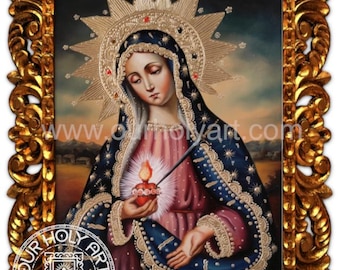 May include: An ornate, gold-framed religious painting. The artwork depicts a figure with a halo, wearing a blue and pink robe, and holding a flaming heart. The frame has intricate carvings. The website address "OURHOLYART.COM" is visible.