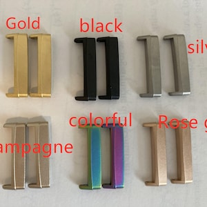 May include: A set of ten watch band buckle clasps in various colors, including gold, black, silver, champagne, colorful, and rose gold.