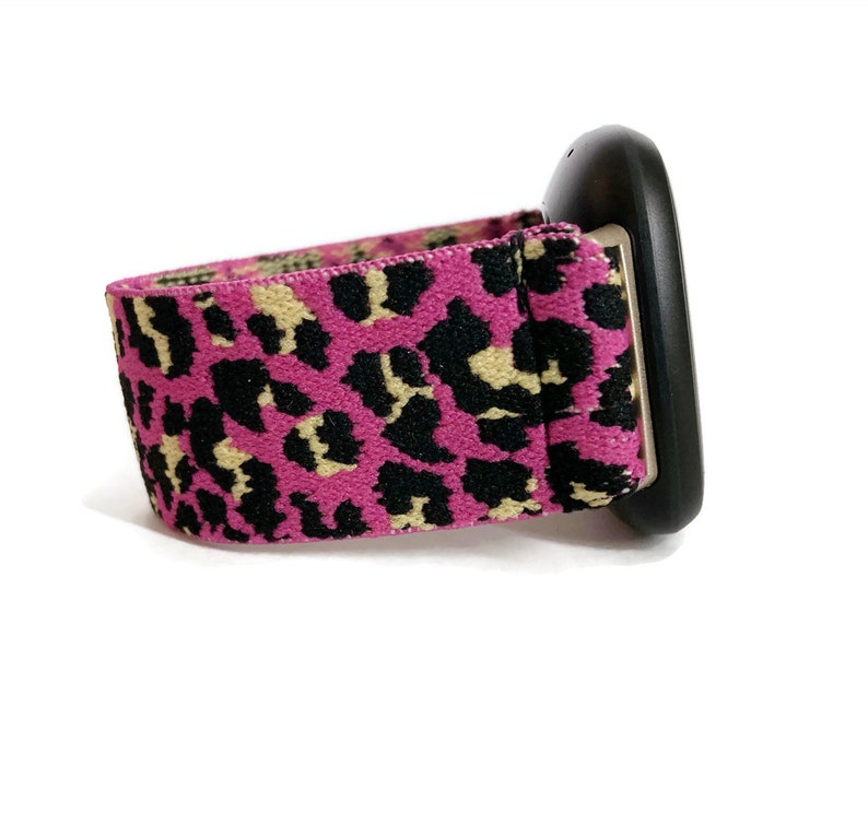 May include: A black and pink leopard print elastic band for a smartwatch.