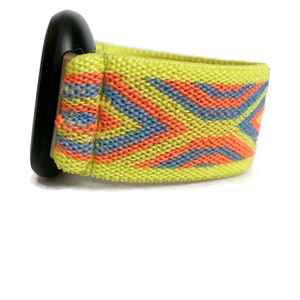 May include: A bright yellow watch band with a geometric pattern in orange and blue. The band is made of a stretchy material.