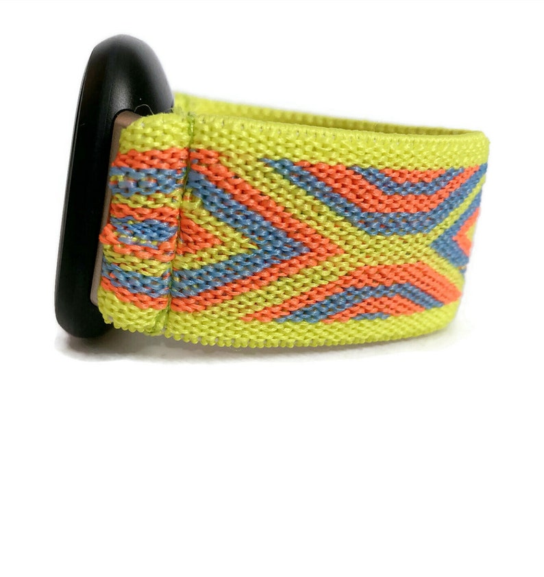 May include: A bright yellow watch band with a geometric pattern in orange and blue. The band is made of a stretchy material.