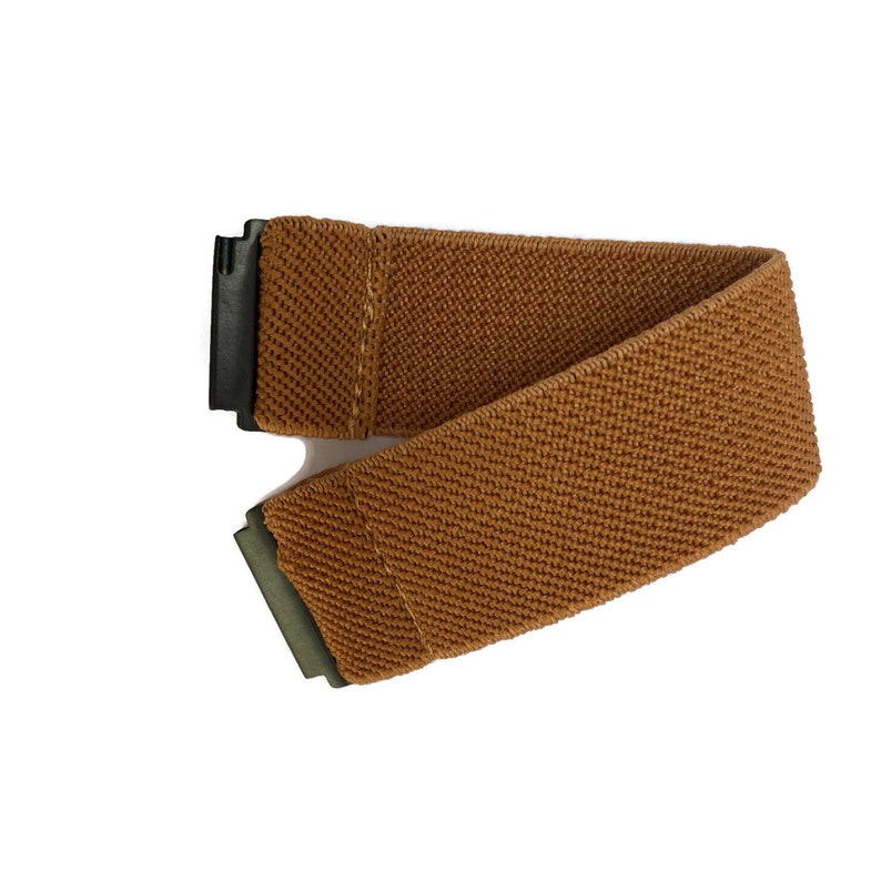 May include: A brown elastic belt with a black buckle and a green metal tip.