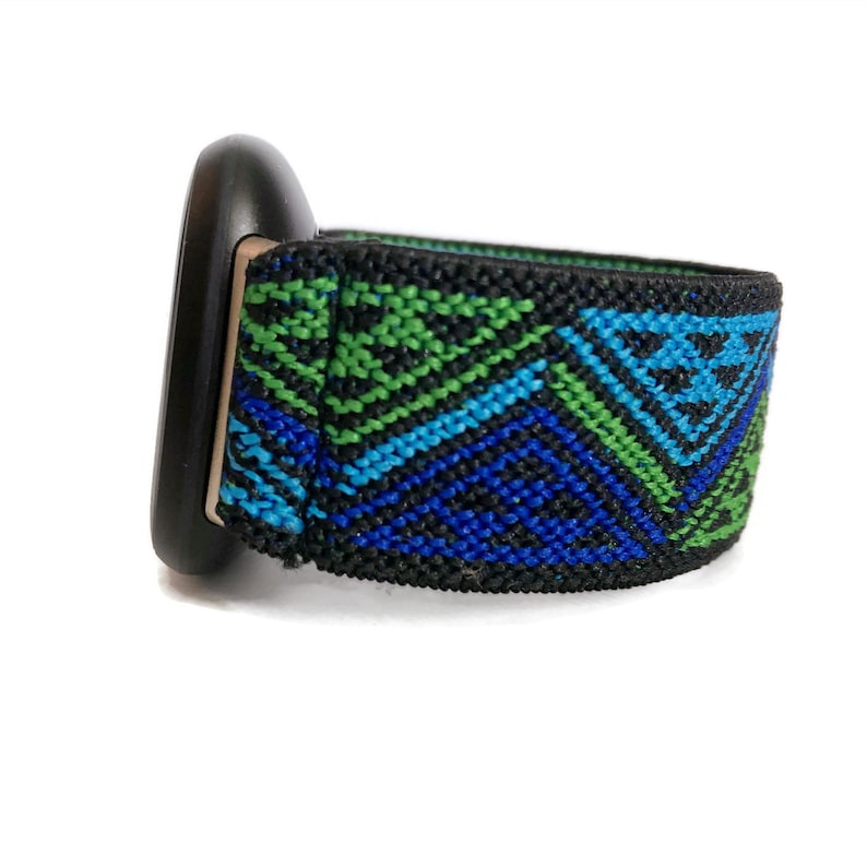 May include: A black watch band with a blue, green, and black geometric pattern.