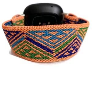 May include: Orange, green, and blue patterned woven elastic watch band.