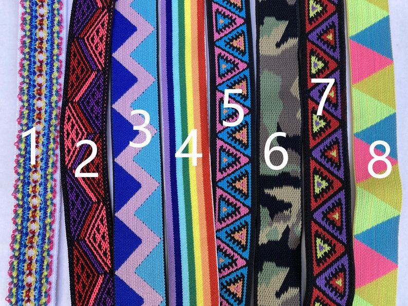 May include: Eight different colorful patterned elastic bands, numbered 1 through 8. The bands are all about 1 inch wide and have various geometric and floral designs.