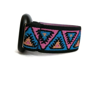May include: Black watch strap with a pink, blue, and orange geometric pattern.