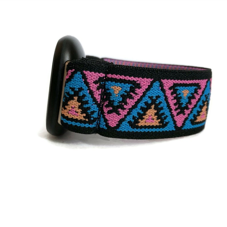 May include: Black watch strap with a pink, blue, and orange geometric pattern.